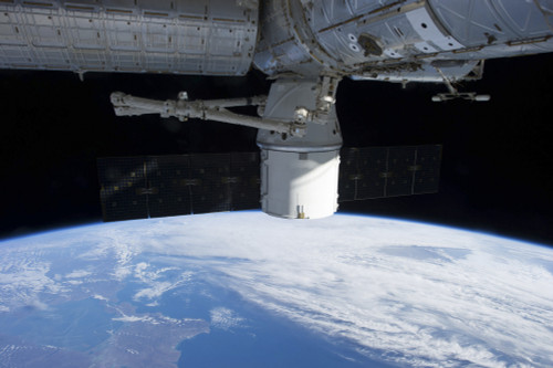 March 3, 2013 - The docking of SpaceX Dragon to the International Space Station above a cloud covered Earth Poster Print - Item # VARPSTSTK204601S