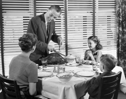 Father carving a turkey at the dinner table Poster Print - Item # VARSAL2554930