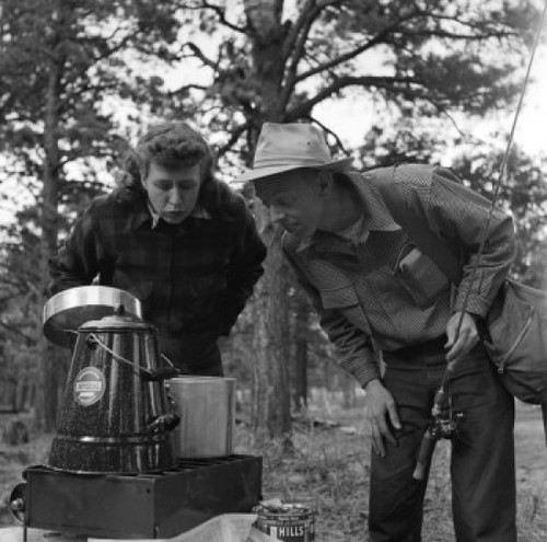 Couple cooking outdoors  man holding fishing rod Poster Print - Item # VARSAL255421143