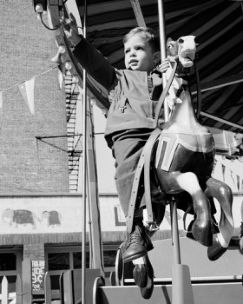 Boy on carousel ride Poster Print - Item # VARSAL255422437