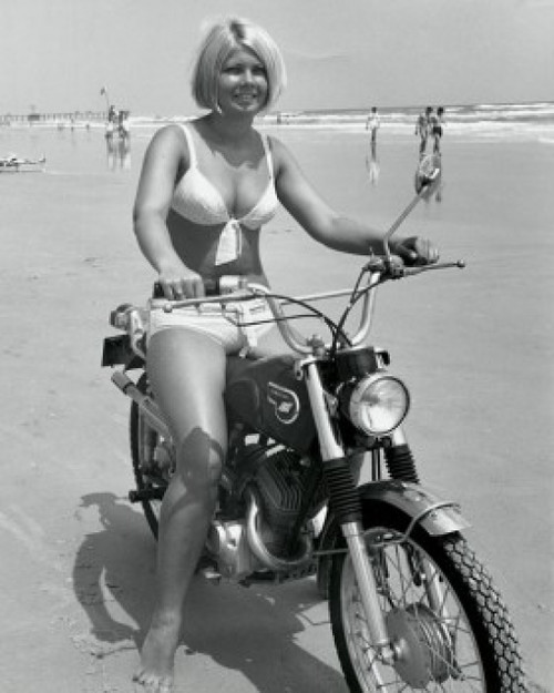 Young woman riding motorcycle on beach Poster Print - Item # VARSAL2552797