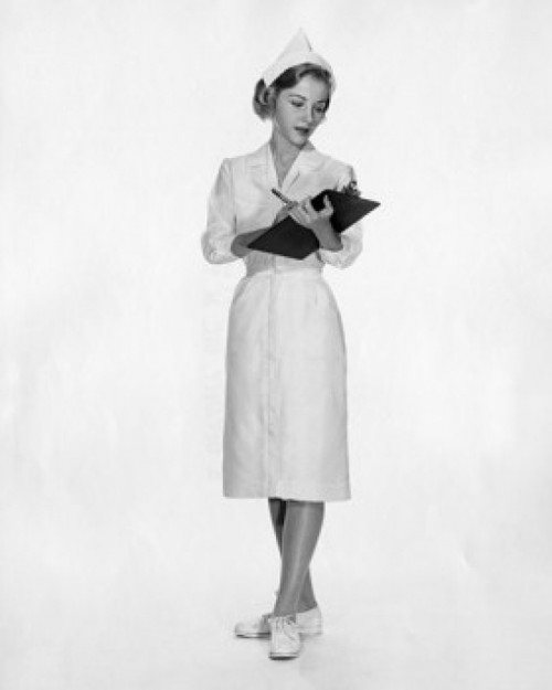 Female nurse writing on a clipboard Poster Print - Item # VARSAL25511709
