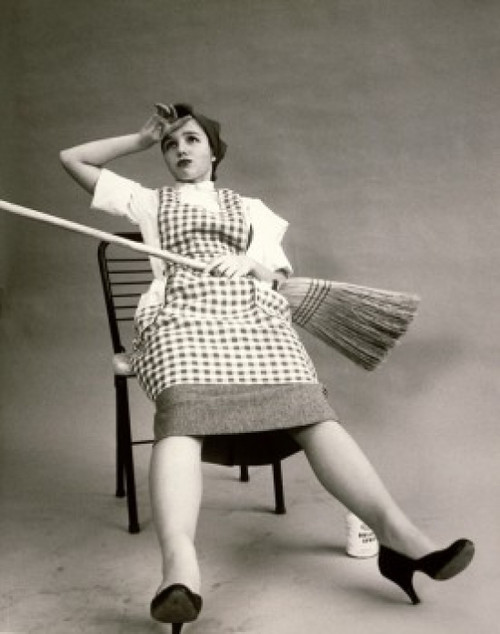 Young woman sitting in a chair holding a broom Poster Print - Item # VARSAL2551474