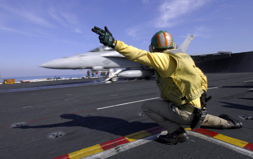 A shooter signals the launch of an F/A-18 Super Hornet Poster Print - Item # VARPSTSTK104341M
