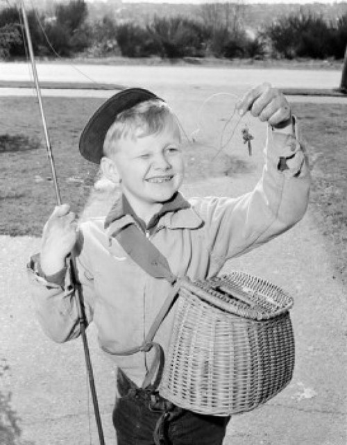 Boy holding fishing bait smiling Poster Print - Item # VARSAL255424536