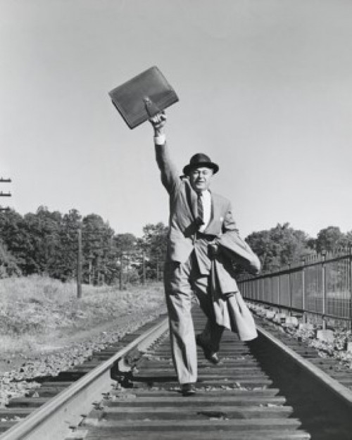 Portrait of a businessman running on railroad tracks Poster Print - Item # VARSAL2559916