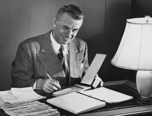 Businessman signing a check in an office Poster Print - Item # VARSAL25548289