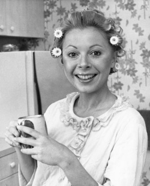 Portrait of a young woman with rollers holding a tea cup Poster Print - Item # VARSAL25512629