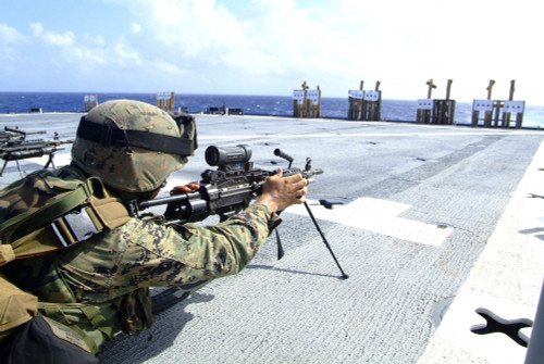 February 15, 2006 - A U.S. Marine adjusts his weapon during a squad automatic weapons live-fire exercise on the flight deck of the amphibious dock landing ship USS Harpers Ferry. Poster Print - Item # VARPSTSTK103097M