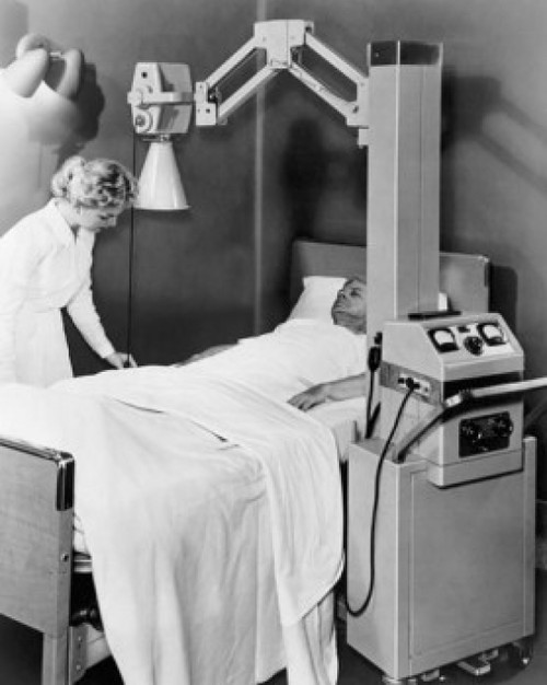 Female nurse adjusting the sheet of a patient in an X-Ray room Poster Print - Item # VARSAL25533907