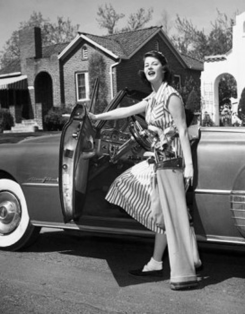 Young woman opening the door of a car Poster Print - Item # VARSAL2554647