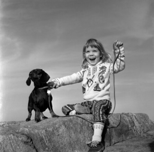 Girl with dog sitting on rock Poster Print - Item # VARSAL25514233