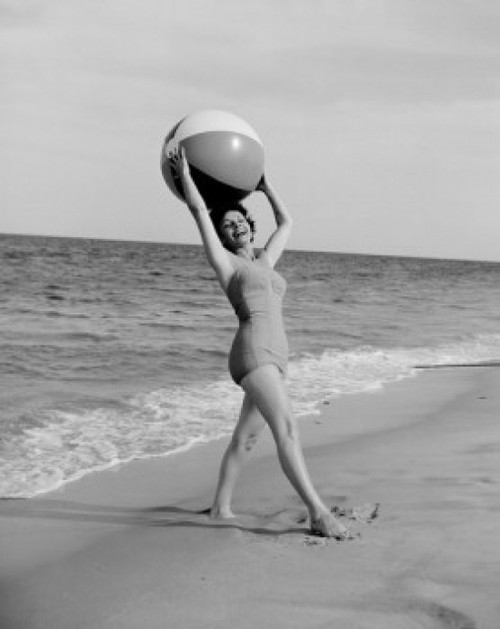 Young happy woman holding beach ball and looking at camera at beach Poster Print - Item # VARSAL255424611