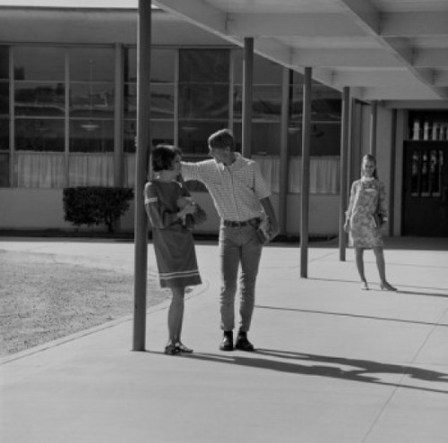 Students flirting at campus Poster Print
