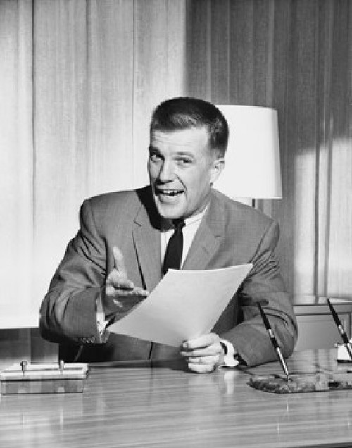 Businessman sitting at a desk and holding documents in an office Poster Print - Item # VARSAL25548386