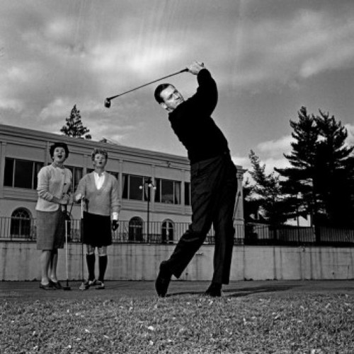 Mature man plying golf while pair of women is watching Poster Print - Item # VARSAL255417760