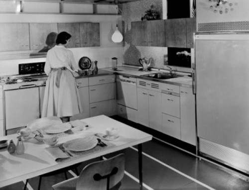 Rear view of a young woman preparing food in a kitchen Poster Print - Item # VARSAL2557762
