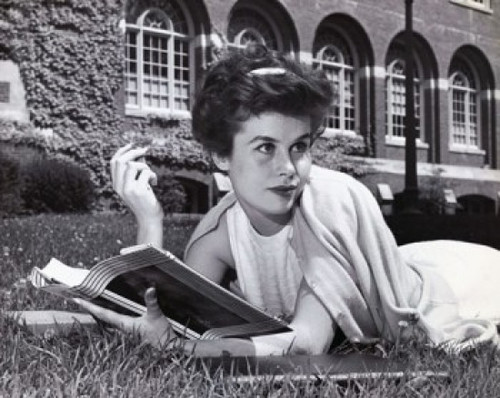 Young woman lying on the grass and holding a book Poster Print - Item # VARSAL25512566
