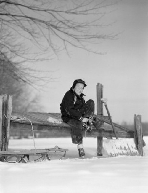 Boy putting on ice skates Poster Print - Item # VARSAL255417001