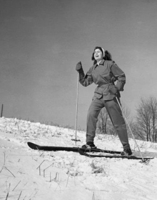 Low angle view of a young woman skiing on snow Poster Print - Item # VARSAL25522943