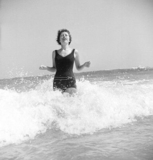 Young woman standing in surf Poster Print - Item # VARSAL255422190