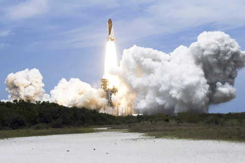 Space Shuttle Atlantis lifts off from its launch pad toward Earth orbit Poster Print