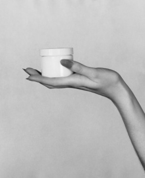 Close-up of a woman's hand holding a jar of moisturizer Poster Print - Item # VARSAL25549490