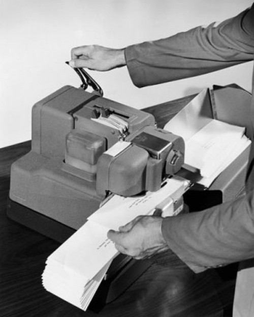 Man's hands operating a postage stamp machine Poster Print - Item # VARSAL25532624