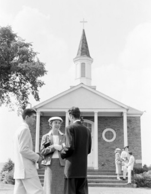 Young couple in front of church Poster Print - Item # VARSAL255419339
