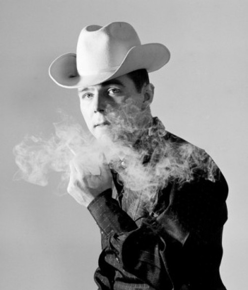 Studio portrait of man wearing cowboy hat smoking cigarette Poster Print - Item # VARSAL25527828B