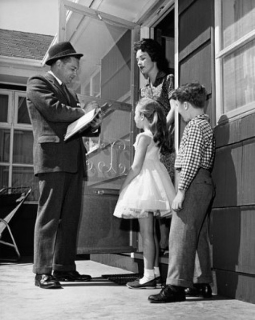 Low angle view of a surveyor talking to a family Poster Print - Item # VARSAL2551399A