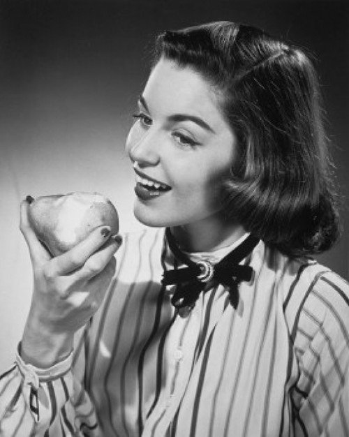 Close-up of a young woman eating a pear Poster Print - Item # VARSAL2553431