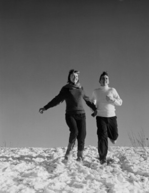 Young couple running down snowy hill Poster Print - Item # VARSAL255422685