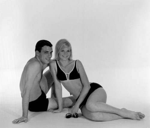 Young couple wearing swimsuits sitting on floor Poster Print - Item # VARSAL255417825