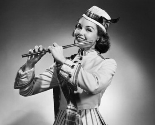 Close-up of a young woman holding a flute and smiling Poster Print - Item # VARSAL2553371B