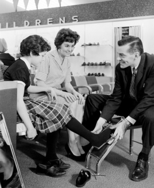 Shop assistant measuring girls foot in shoe shop Poster Print - Item # VARSAL255417877