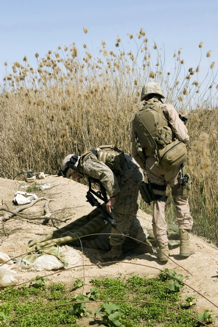 March 9, 2007 - Marines search around an Iraqi home north of Hit, Iraq, for weapons caches. Poster Print - Item # VARPSTSTK102284M March 9, 2007 - Marines search around an Iraqi home north of Hit, Iraq, for weapons caches. Poster Print - Item # VARPSTSTK102284M
