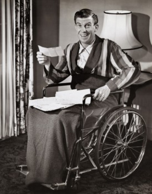Portrait of a mature man sitting on a wheel chair smiling about a check Poster Print - Item # VARSAL2553531