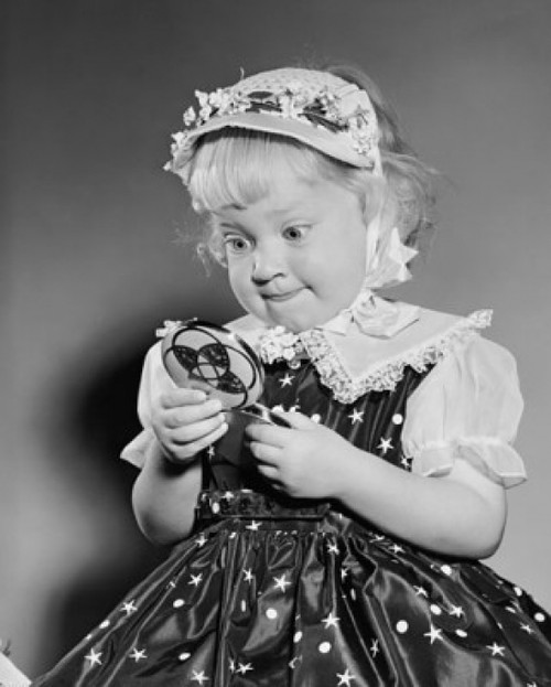 Close-up of a girl looking in a hand mirror Poster Print - Item # VARSAL2552024B