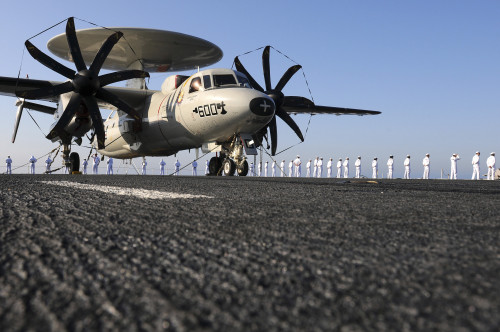An E-2C Hawkeye sits on the flight deck of USS Abraham Lincoln while sailors man the rails Poster Print - Item # VARPSTSTK104512M