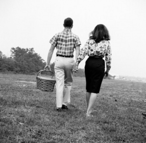 Young couple with picnic basket  walking in field Poster Print - Item # VARSAL255417669