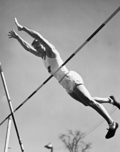 Low angle view of a young man pole vaulting Poster Print - Item # VARSAL25518586C