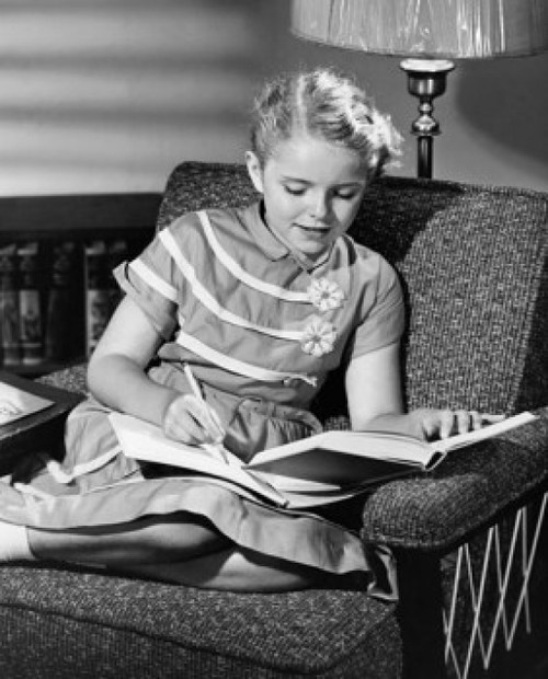 Girl sitting in an armchair and studying Poster Print - Item # VARSAL25513870C