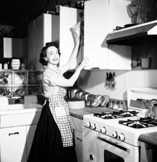 Portrait of a young woman working in a kitchen Poster Print - Item # VARSAL25538371