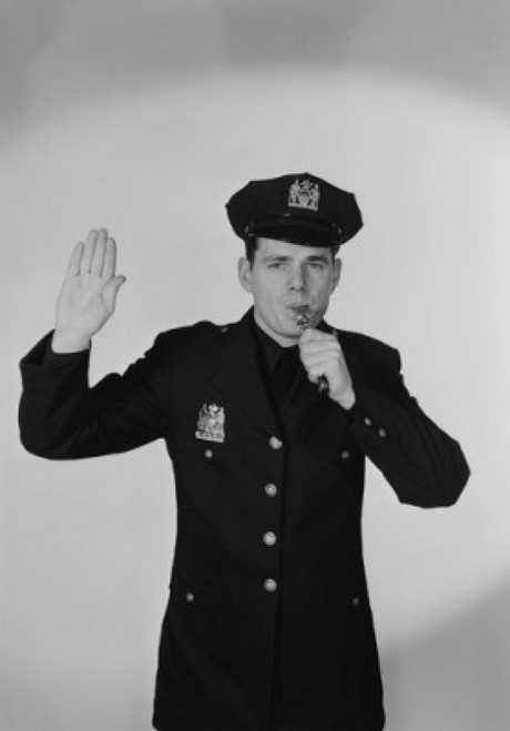 Portrait of young police officer using whistle Poster Print