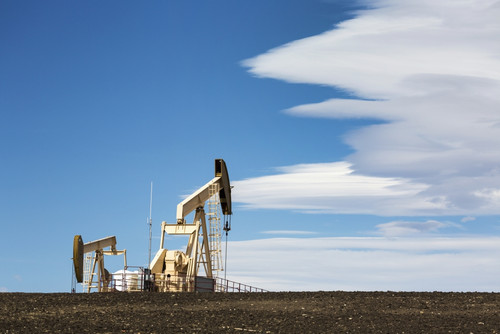 Two pumpjacks on a hill with dramatic clouds in the blue sky; Alberta, Canada PosterPrint - Item # VARDPI12277136