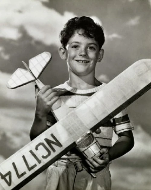Boy holding a model airplane Poster Print
