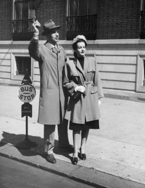 Young man and a young woman waiting at a bus stop Poster Print - Item # VARSAL2553512