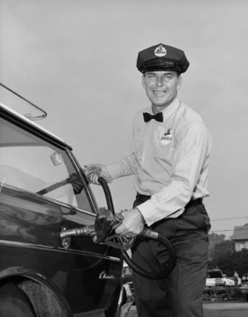 Mid adult man refueling a car at a gas station Poster Print - Item # VARSAL2556641