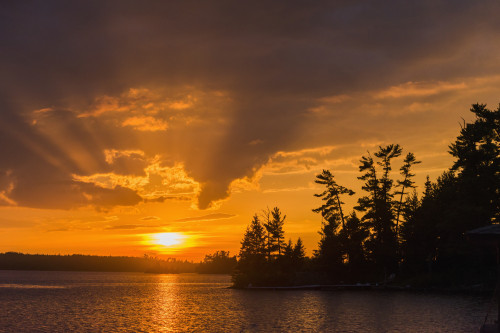 Sunrise casting an orange glow over the sky and reflected in a tranquil lake; Ontario, Canada PosterPrint - Item # VARDPI12303003